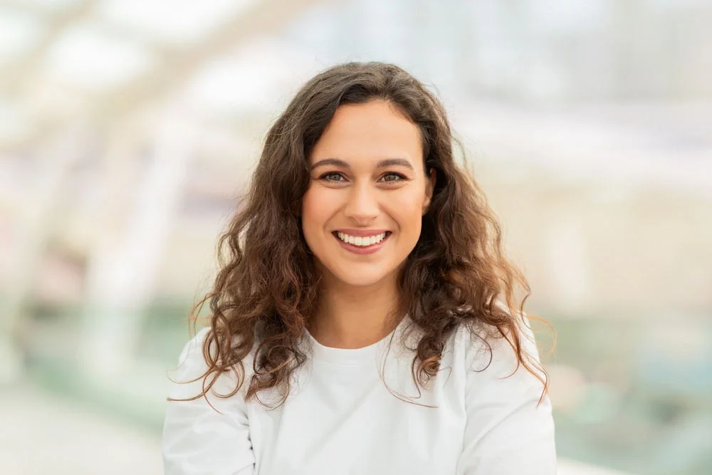 Smiling woman in a bright, welcoming setting
