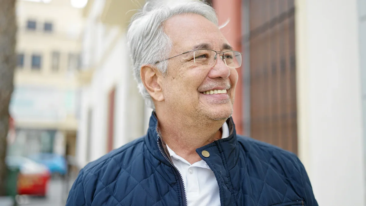 Smiling older man wearing glasses outdoors