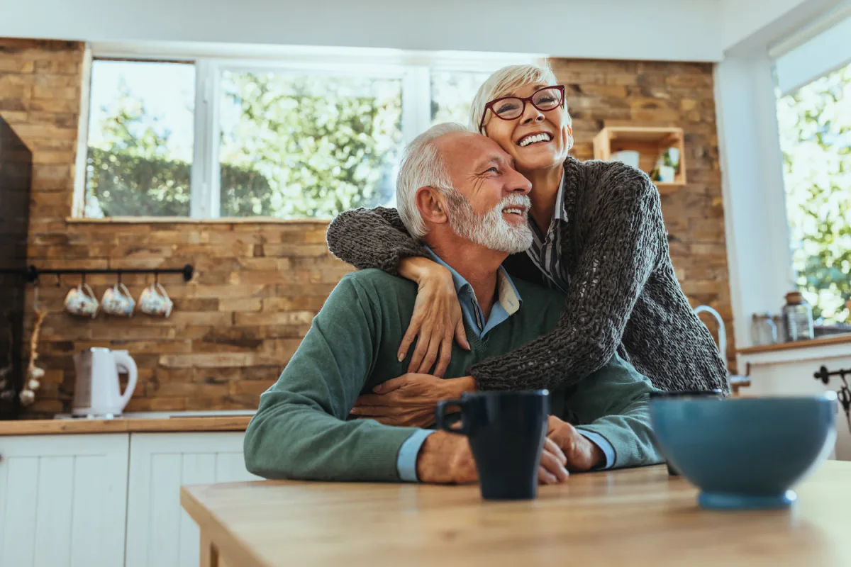 Smiling older couple sharing a joyful moment at home