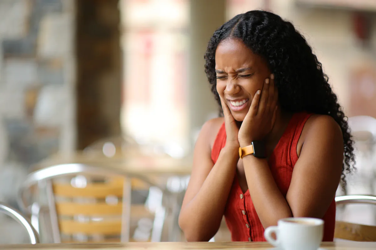 Woman experiencing sudden dental pain