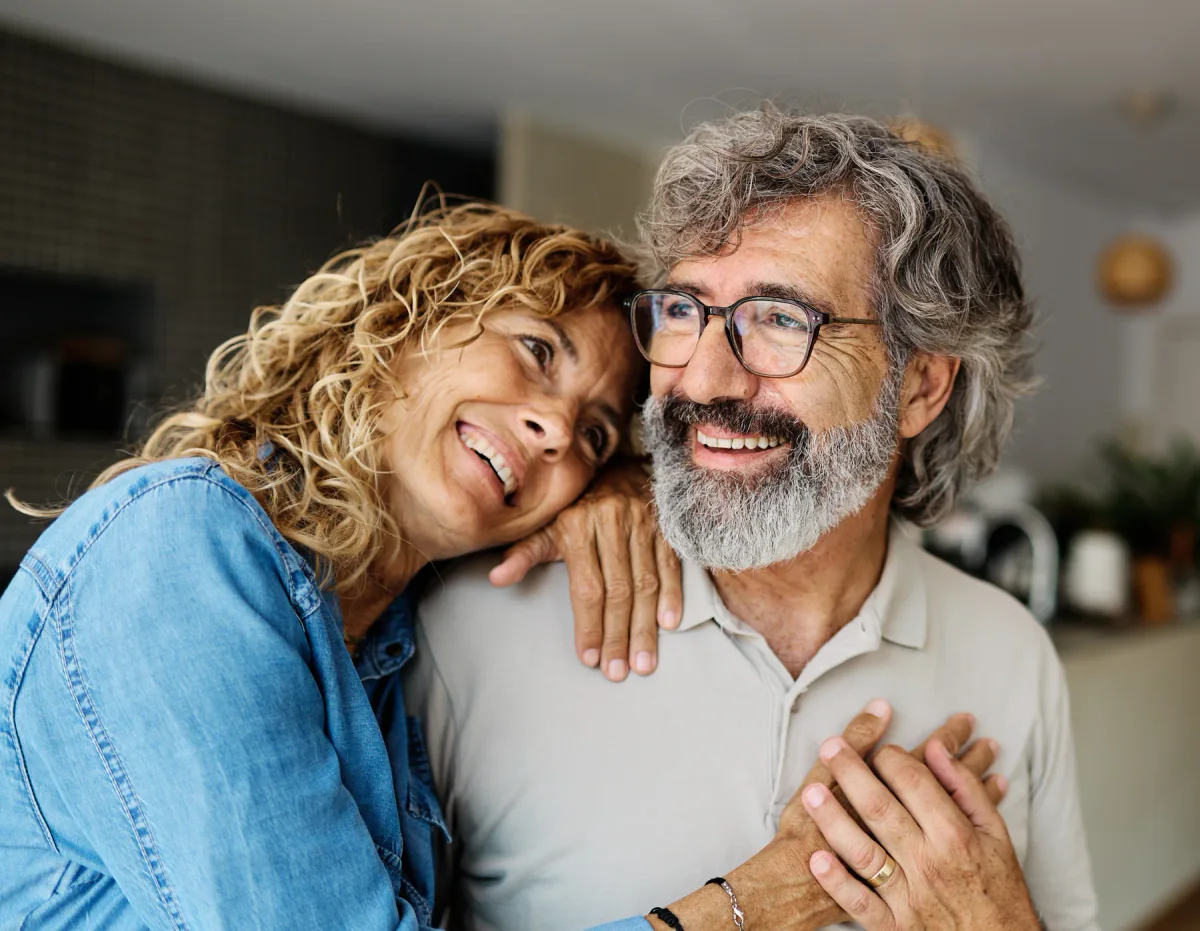 Smiling older couple relaxing together at home